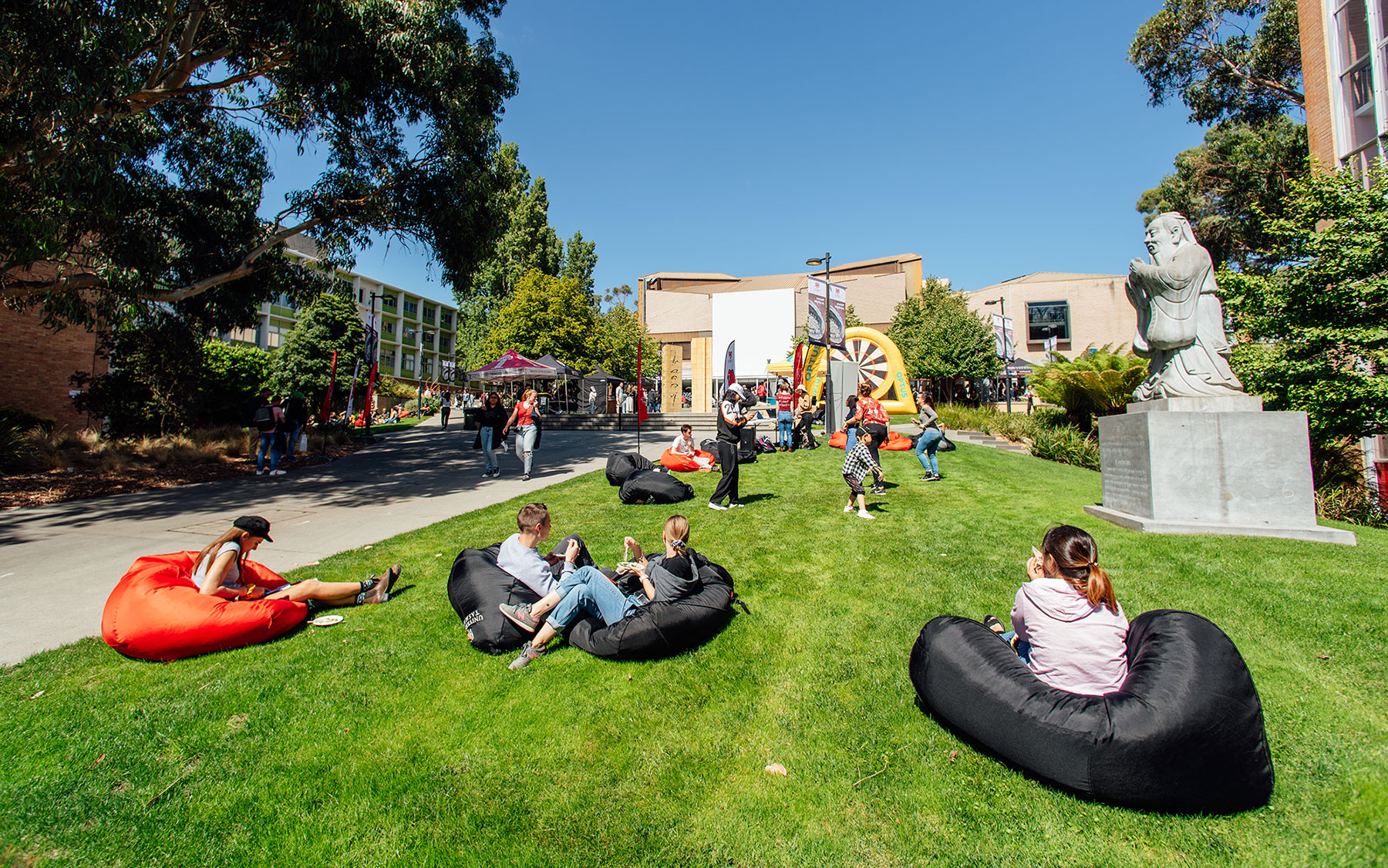 Students relax in bean bags on the lawn Sandy Bay campus.