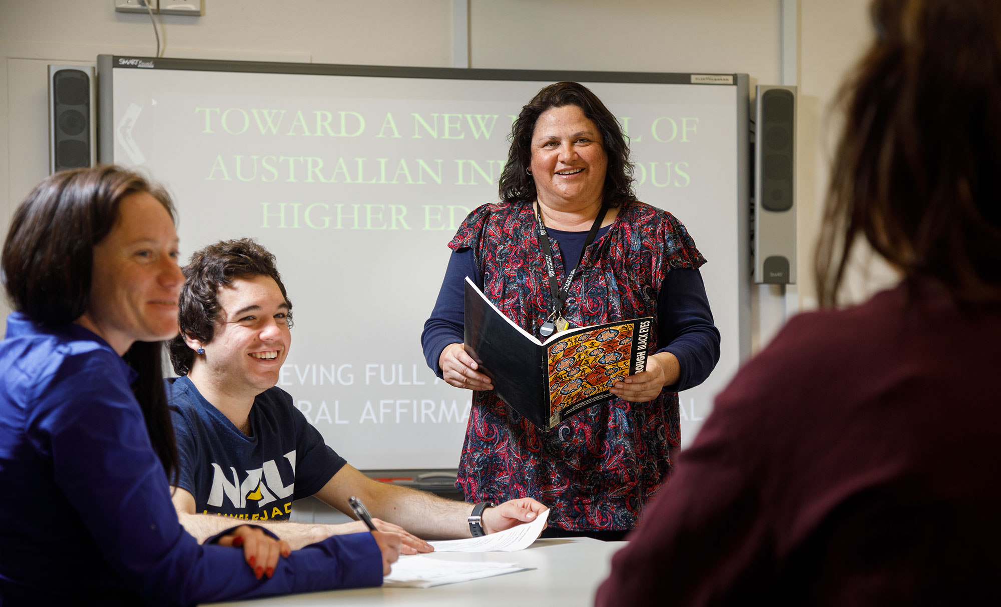 Riawunna lecturer in classoom with students.